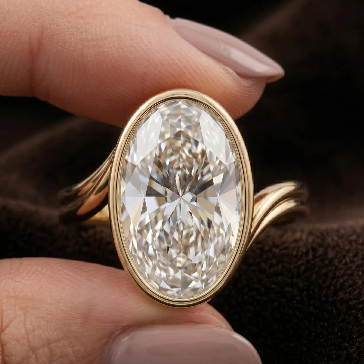 Macro detail of 4 CT oval cut lab diamond showing brilliance in gold bezel setting.