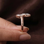 Side profile of rose gold Toi et Moi lab diamond open bezel setting and band.