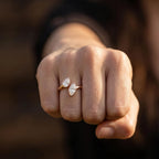 Front facing hand shot featuring pear and marquise lab diamond bezel engagement ring.