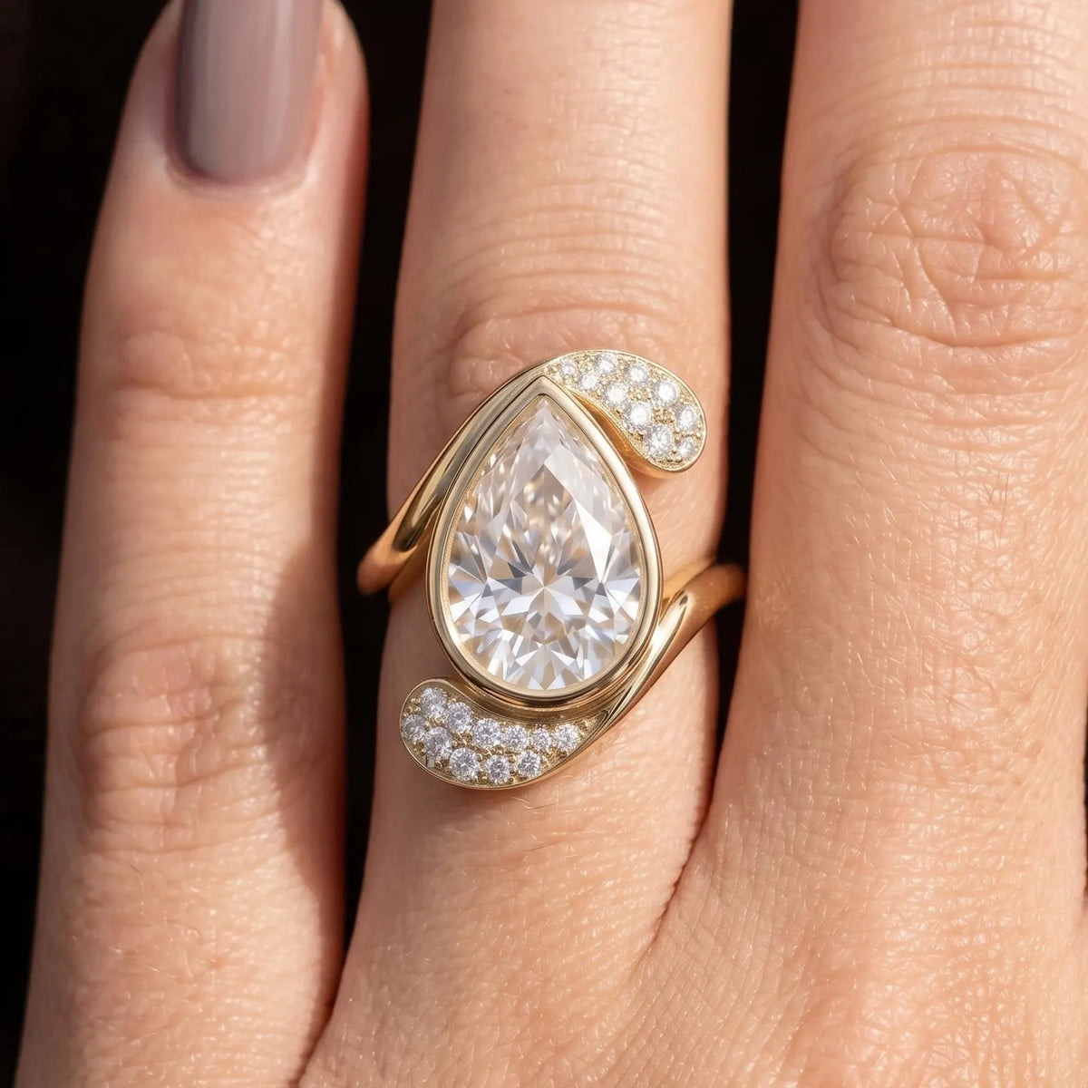 3 carat pear cut lab diamond bezel ring with pavé dynamic band in natural light.
