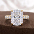 Front view of 4 CT elongated cushion cut diamond ring sitting on textured brown fabric.