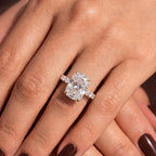Crossed hands showcasing a 4 carat elongated cushion lab grown diamond engagement ring.
