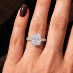 Wearer's hand showing a 4 CT elongated cushion cut lab diamond ring with round side accents.