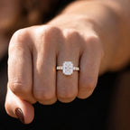 Front facing hand shot featuring 4 CT elongated cushion lab diamond ring in natural sunlight.