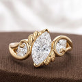 Studio shot of a 2 CT marquise lab grown diamond ring featuring Art Nouveau leaf scroll detailing on textured background.