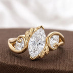 Studio shot of a 2 CT marquise lab grown diamond ring featuring Art Nouveau leaf scroll detailing on textured background.