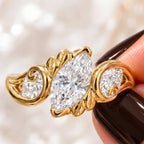 Detailed macro view showcasing the sculpted leaves and side diamond accents on a marquise lab diamond ring.