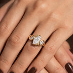 Styled hand displaying the brilliant sparkle of a 2 CT marquise diamond nature-inspired gold ring.