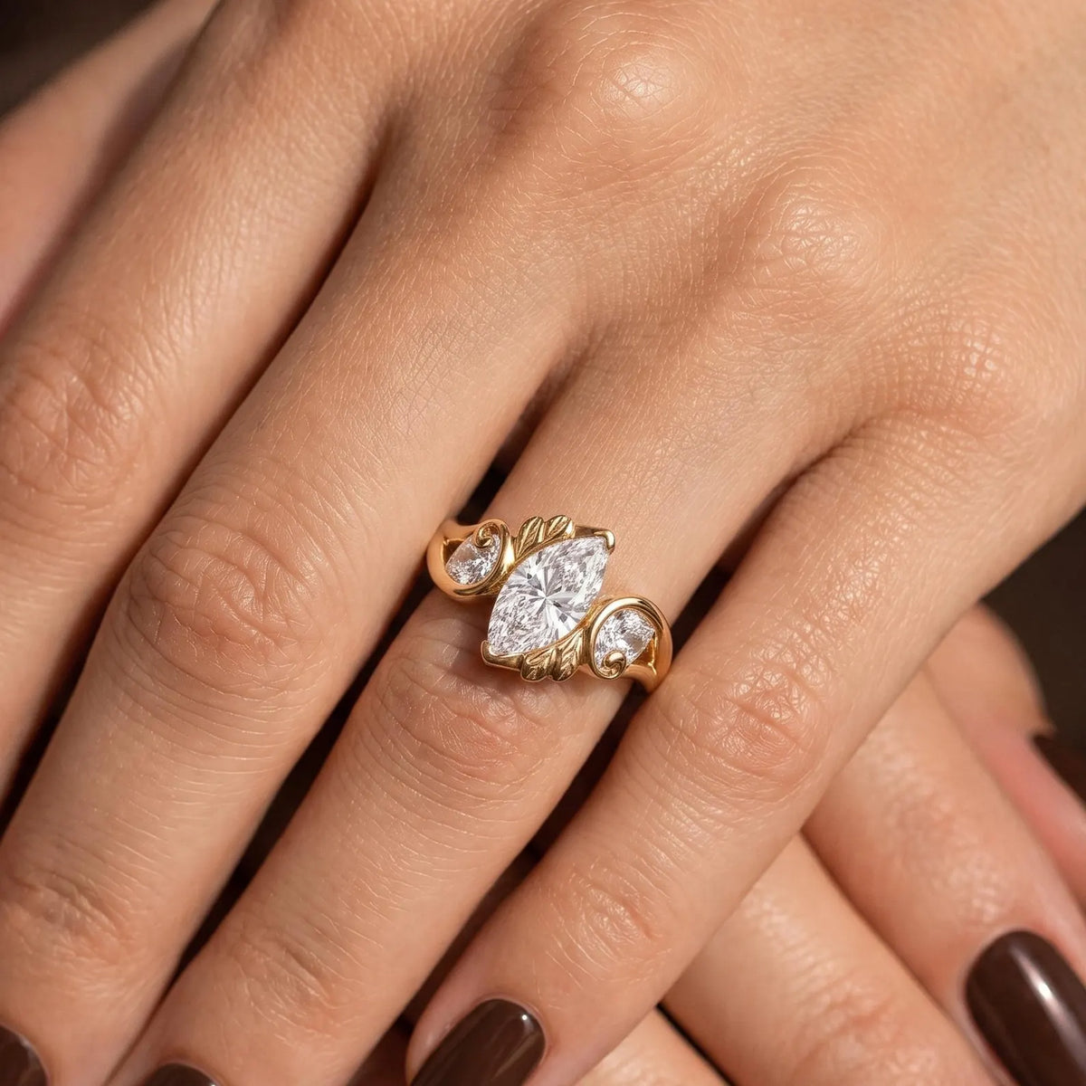 Styled hand displaying the brilliant sparkle of a 2 CT marquise diamond nature-inspired gold ring.