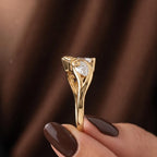 Vertical profile detail of the smooth gold band and intricate side leaf bypass craftsmanship.