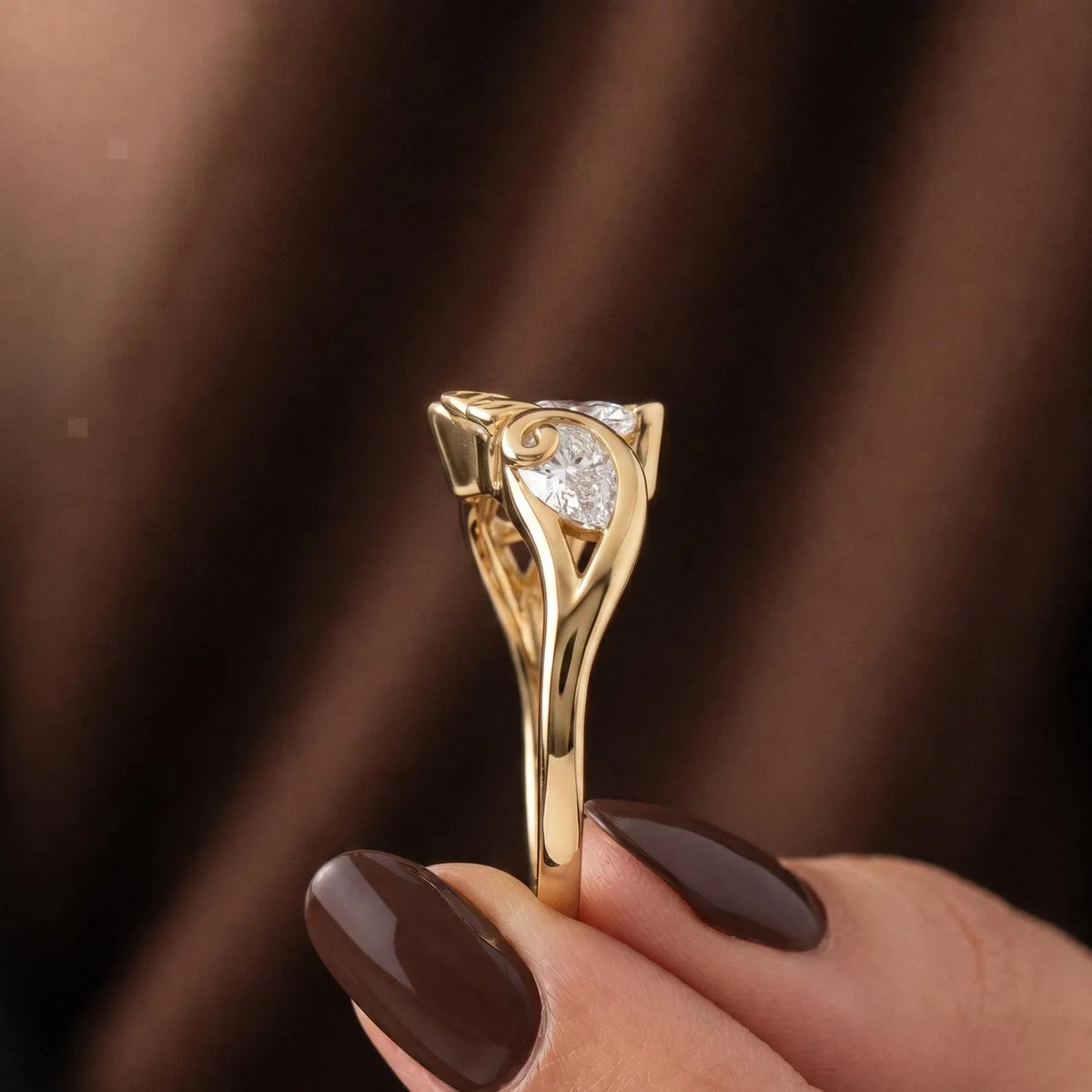 Vertical profile detail of the smooth gold band and intricate side leaf bypass craftsmanship.