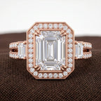 Top-down macro view of 3 carat emerald cut lab grown diamond ring with halo setting and baguette side stones in rose gold.