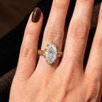 Direct top view of a 3 CT marquise cut lab grown diamond ring featuring ornate scrollwork on the gold shank.