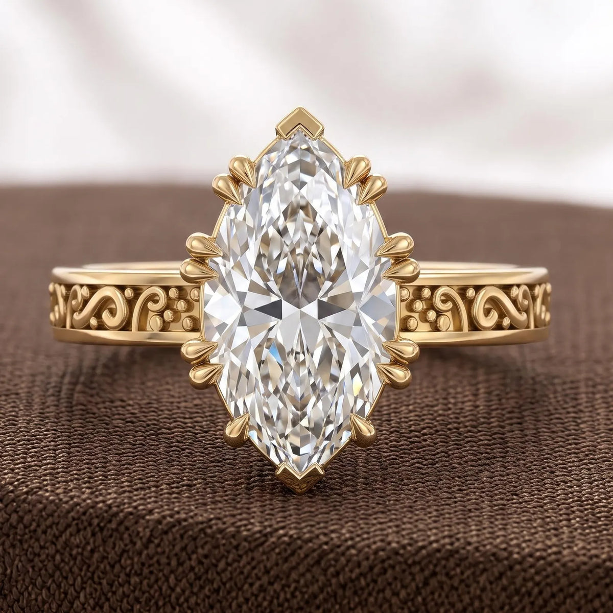 Frontal display of a 3 carat marquise cut lab grown diamond ring with intricate antique scrollwork band on brown fabric.