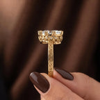 Side profile shot showing the crown gallery setting with hidden accent diamonds and filigree band detail.