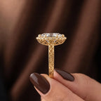 Side profile view of vintage yellow gold marquise lab diamond halo ring showing carved undergallery scrollwork and engraved band.