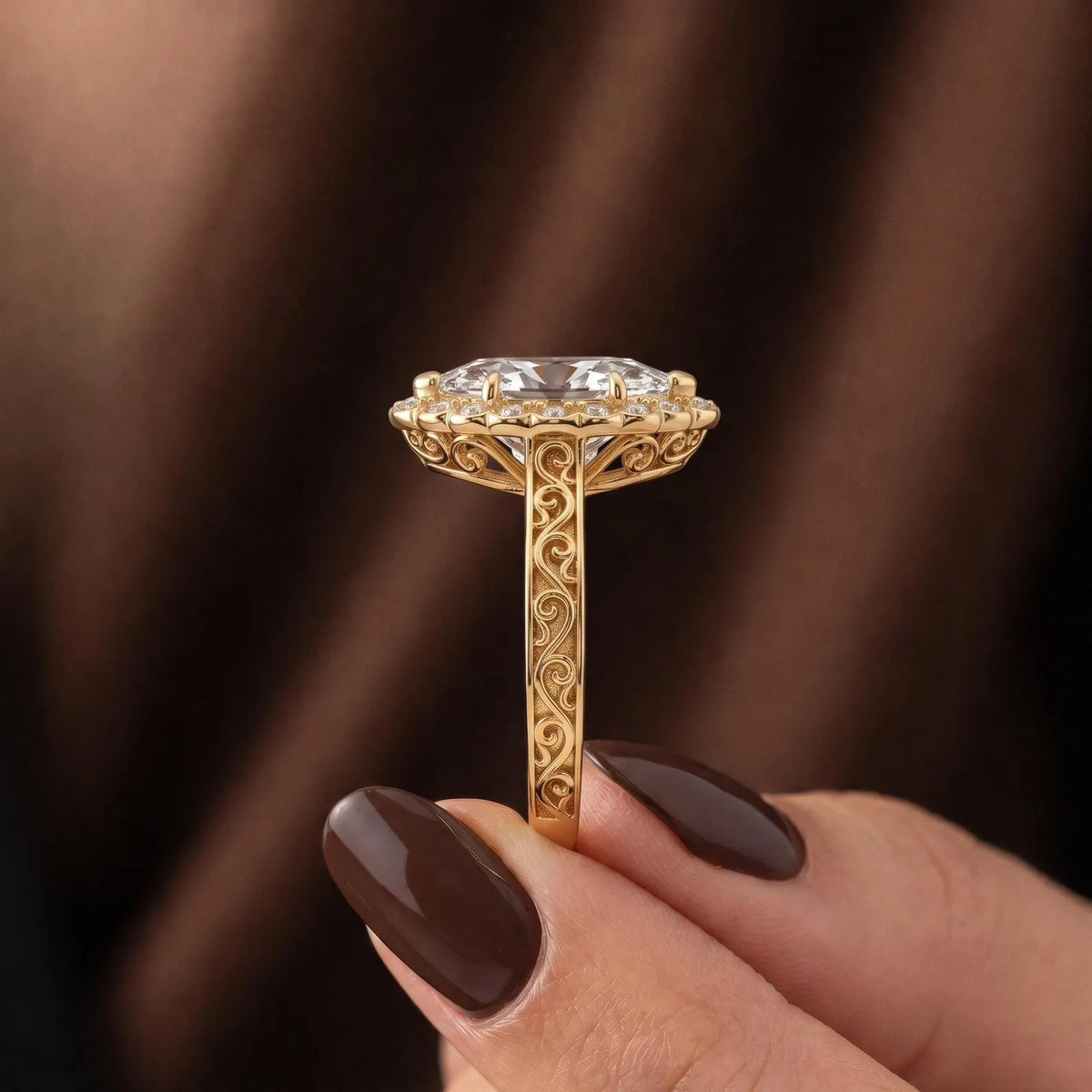 Side profile view of vintage yellow gold marquise lab diamond halo ring showing carved undergallery scrollwork and engraved band.
