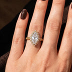 Direct on-hand view of a 3 carat marquise cut lab created diamond ring with vintage diamond halo set in 14k yellow gold.