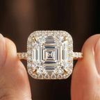 Ultra close-up of a 3 CT Asscher cut lab diamond showing step cut facet pattern, corner prongs, and halo accents.