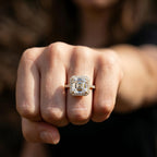 Front perspective shot of a 3ct Asscher cut lab created diamond ring with pave band worn on finger.