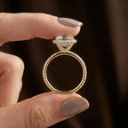Side profile view of Asscher lab diamond engagement ring held between fingers highlighting pave basket gallery and thin pave shank.