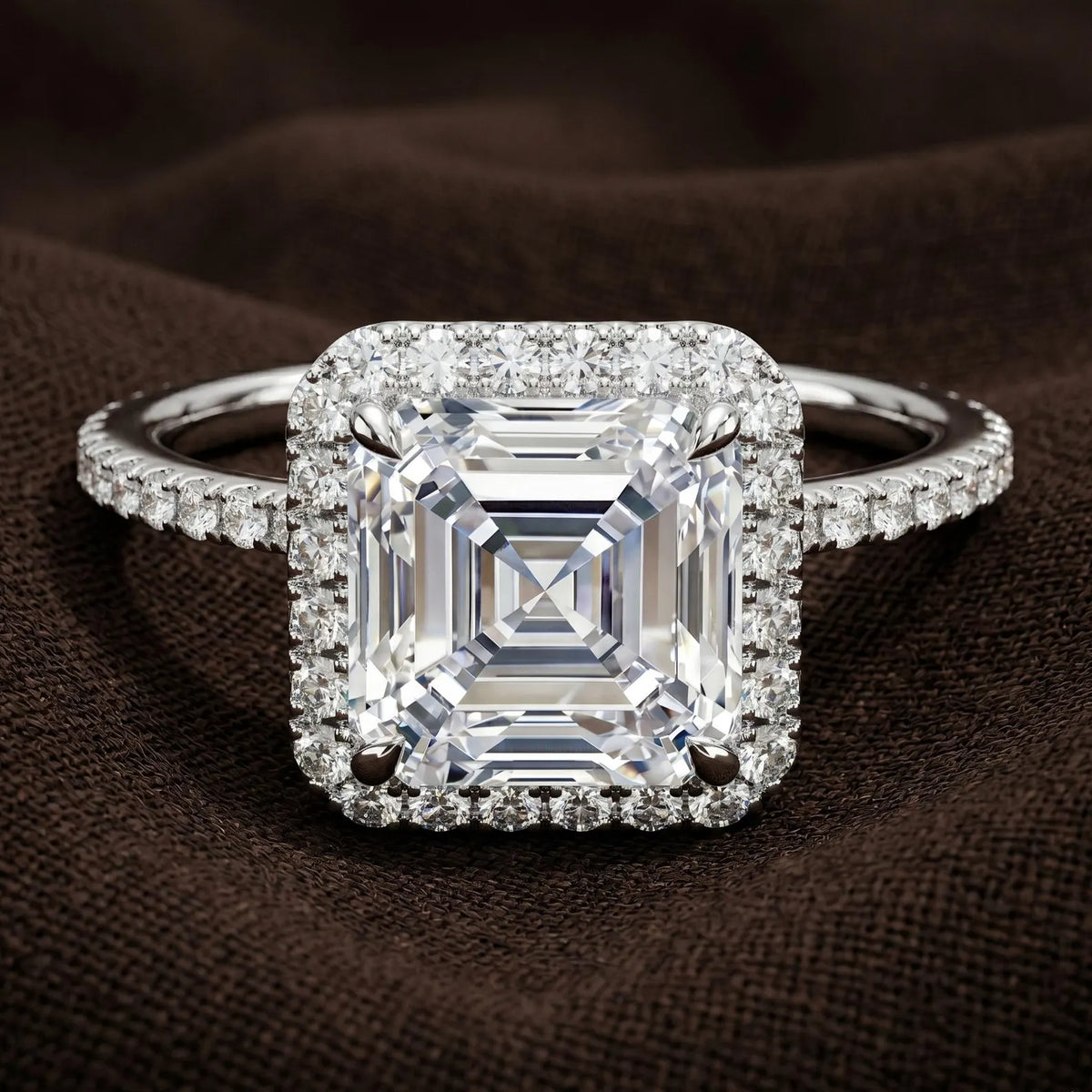 Studio macro shot of 3 CT Asscher cut lab grown diamond halo ring in white gold or platinum setting option.