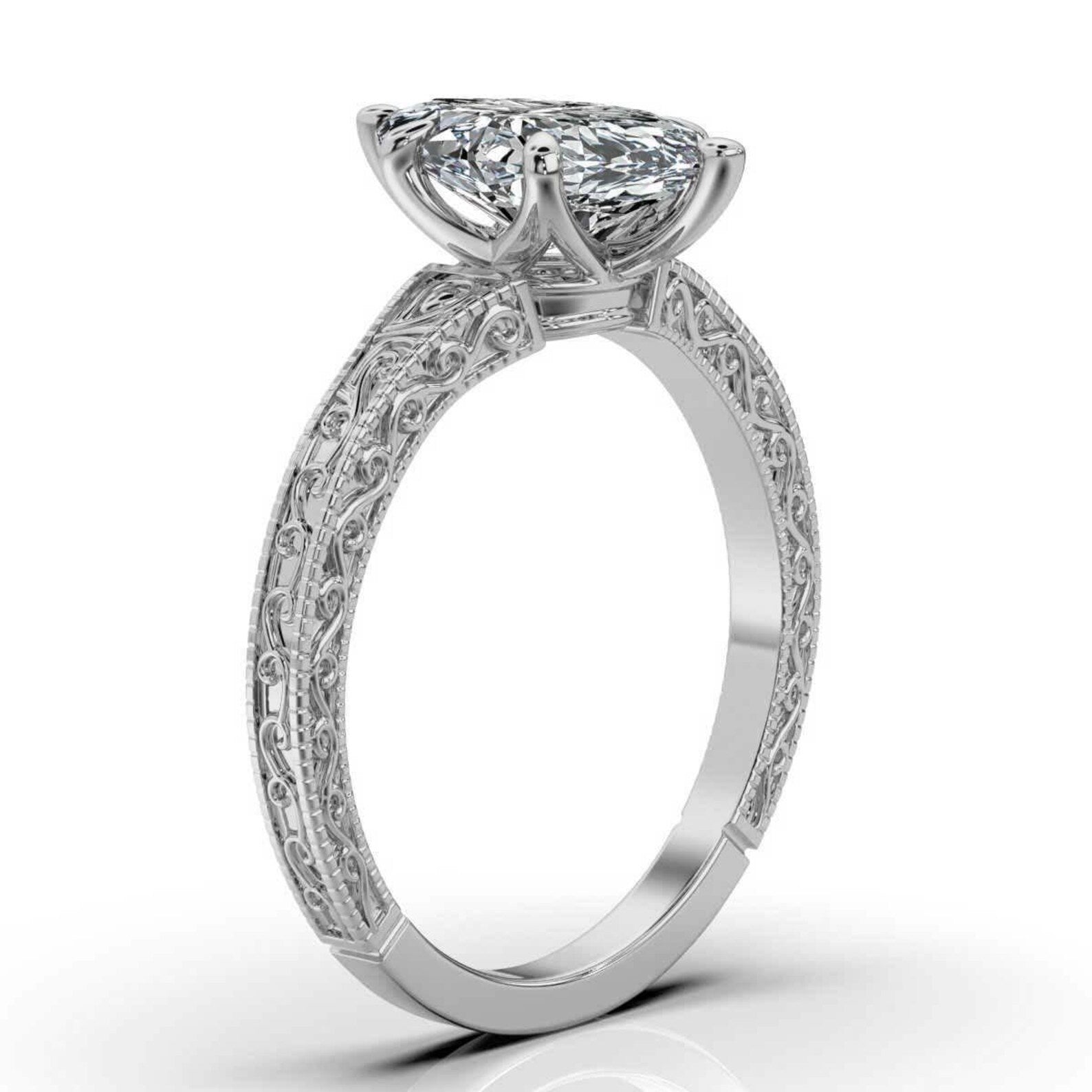Side perspective view of a 3 carat marquise cut lab grown diamond ring in white gold with vintage scrollwork engraving.