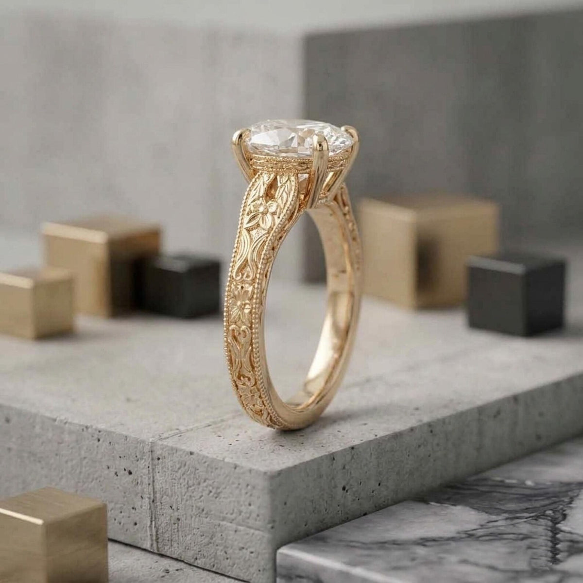 Vertical standing view of a 2 carat oval diamond solitaire ring displaying full engraved pattern on yellow gold band.
