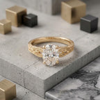 Direct top view of a 2 CT oval cut lab diamond showing brilliant facet pattern and split filigree shoulders in 14K gold.