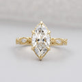 Top view of a 3 carat marquise cut lab grown diamond engagement ring in 14K yellow gold featuring a vintage lattice band and 6-prong head.