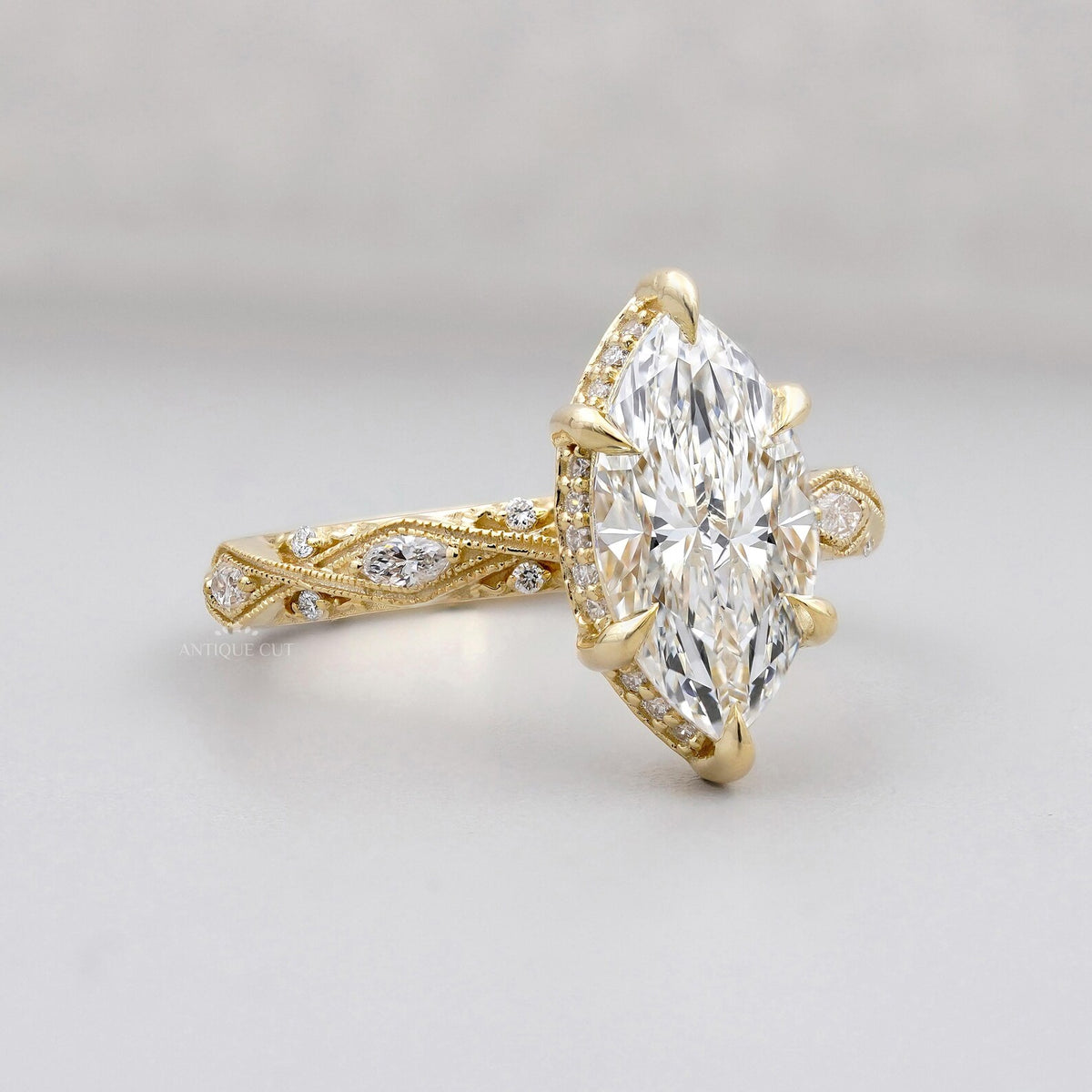 Perspective view of a 3 CT marquise lab grown diamond ring showcasing the hidden halo setting and intricate filigree shank.