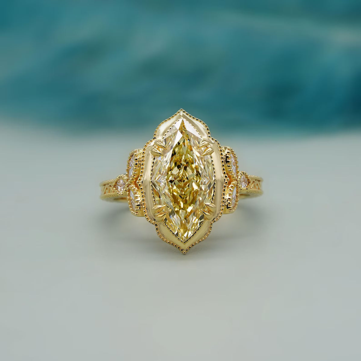 Top-down view of a 4 CT fancy yellow marquise cut lab grown diamond in a scalloped milgrain halo setting.