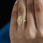Close-up hand shot showing a 4 carat fancy yellow marquise lab grown diamond vintage ring.