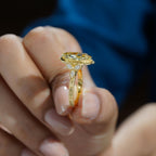 Profile view of a hand holding a 4 CT yellow marquise lab diamond ring displaying the hand-engraved filigree band.