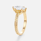 Side profile of a 2 CT marquise cut lab grown diamond ring in 14k yellow gold showcasing Celtic knot filigree and prong setting.