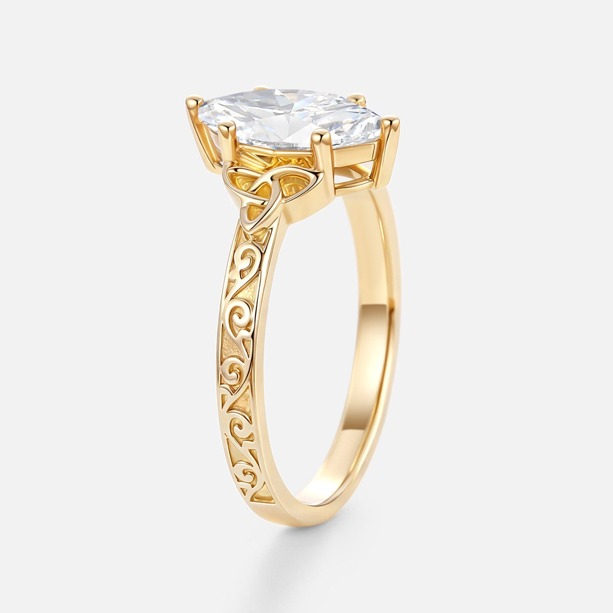 Side profile of a 2 CT marquise cut lab grown diamond ring in 14k yellow gold showcasing Celtic knot filigree and prong setting.