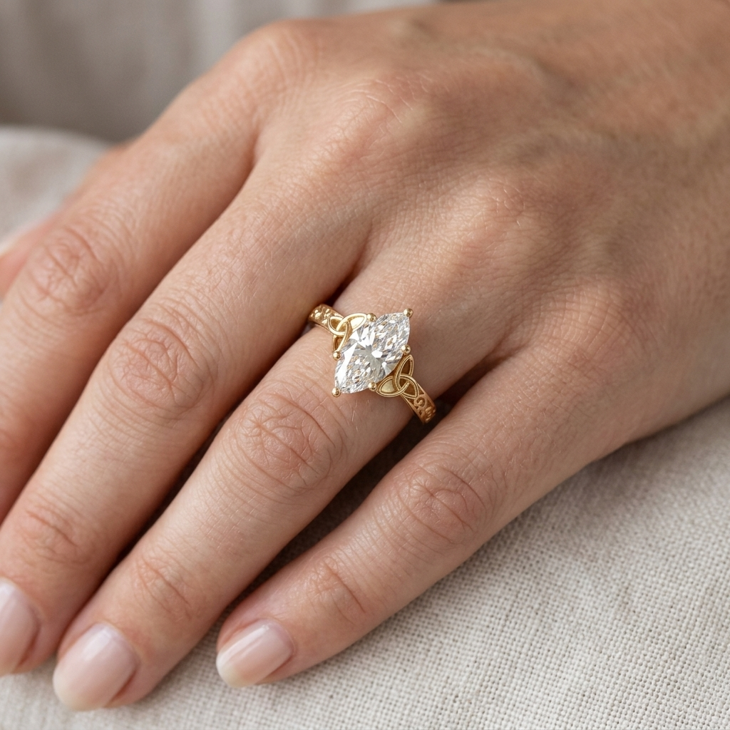 Close-up model photo of a 2 carat marquise lab grown diamond engagement ring with vintage Celtic scrollwork worn on hand.