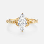 Top-down front view of a 2ct marquise lab created diamond set in a 14k yellow gold Trinity knot band.