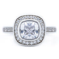 Top view of a 2 CT cushion cut lab grown diamond engagement ring with a bezel halo setting in 14k white gold.