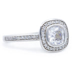Angled view of a 2 carat cushion lab diamond ring featuring a micro pave halo and diamond-accented band.