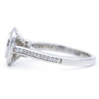 Side profile showing the cathedral pave shank and elevated bezel halo head of a white gold cushion diamond ring.