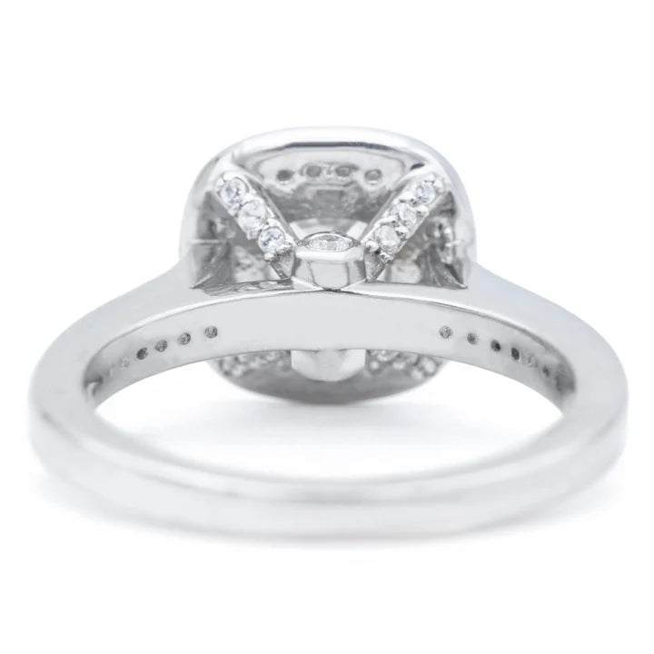 Underside gallery view of a cushion lab diamond engagement ring showing hidden pave accents on the basket struts.
