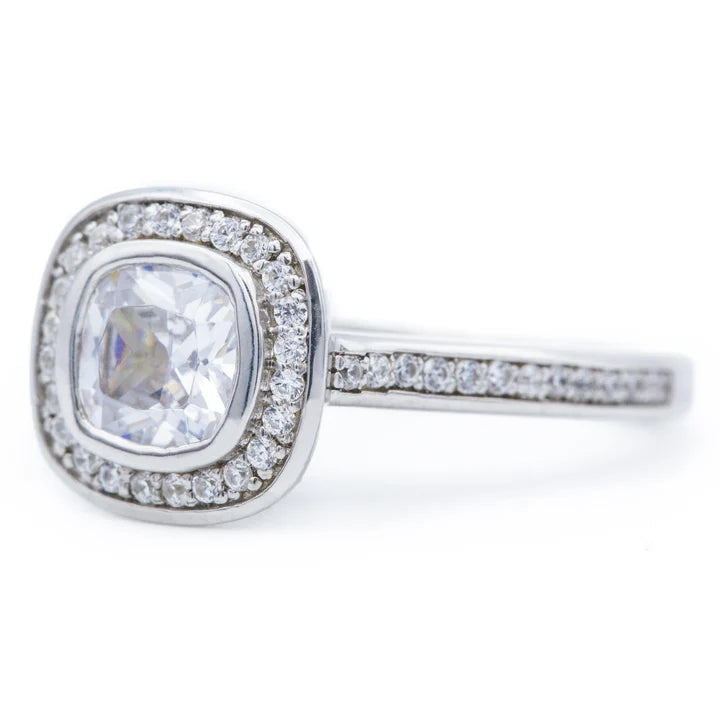 Close-up side angle of a 2ct cushion lab grown diamond halo ring in solid 14k white gold.