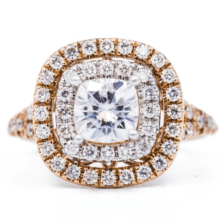 Top view of a 2 CT cushion cut lab grown diamond engagement ring with two-tone double halo and split shank band.