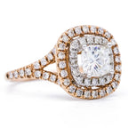Perspective view of a 2 carat cushion lab diamond ring featuring a two-tone pave double halo and diamond split shank.