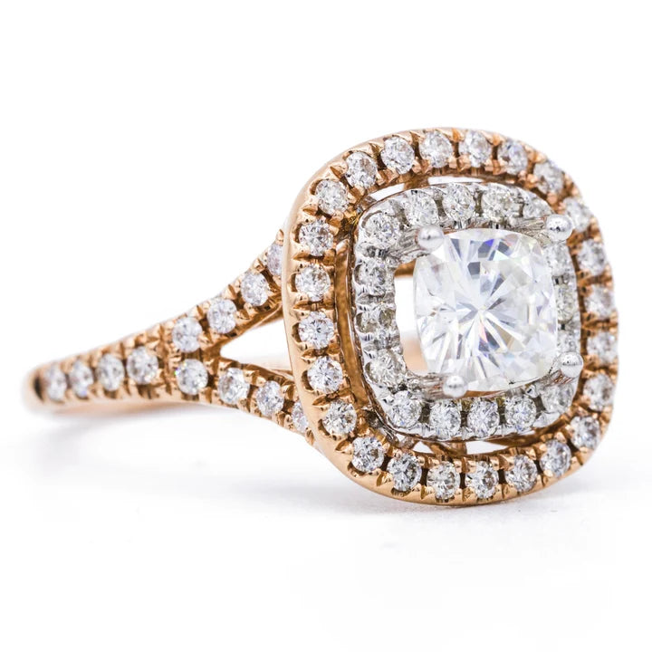 Perspective view of a 2 carat cushion lab diamond ring featuring a two-tone pave double halo and diamond split shank.