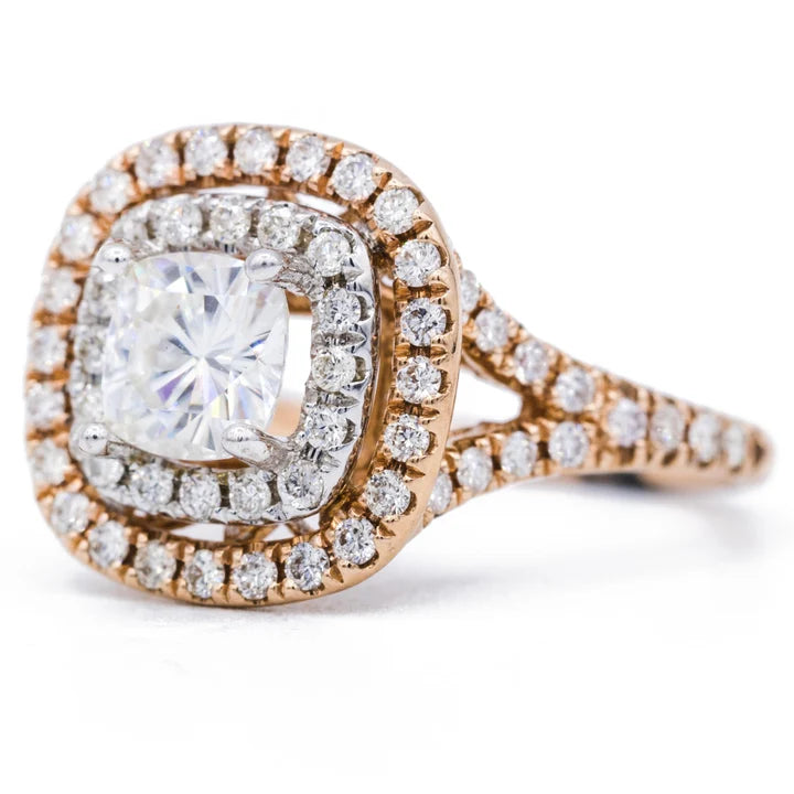 Angled side view of a two-tone cushion cut lab grown diamond halo ring in rose gold and white gold.