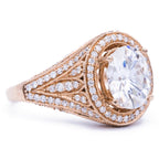 Angled view of a 3 carat oval lab diamond ring featuring detailed milgrain pave band in 14k rose gold.