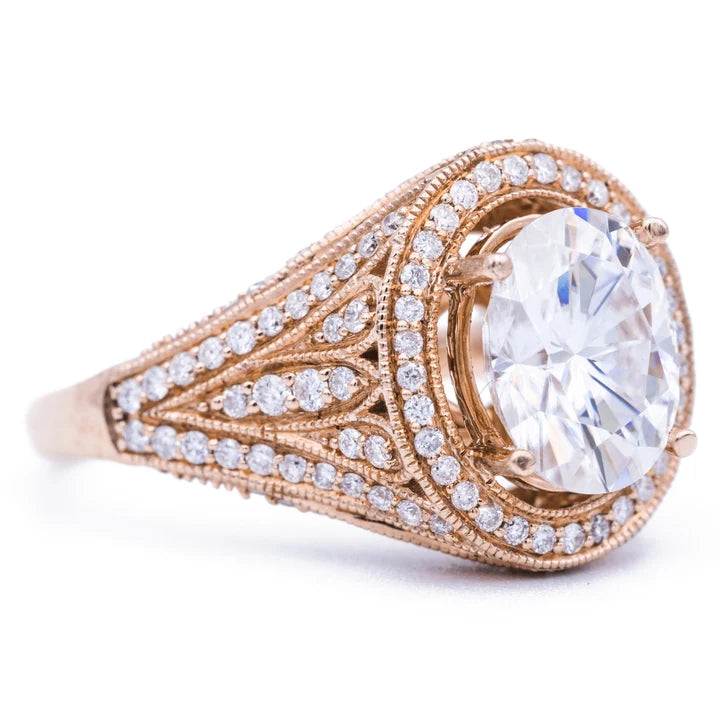 Angled view of a 3 carat oval lab diamond ring featuring detailed milgrain pave band in 14k rose gold.