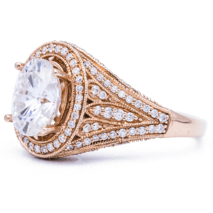 Perspective shot displaying the wide filigree and pave diamond shoulder of a 3ct oval lab diamond ring.